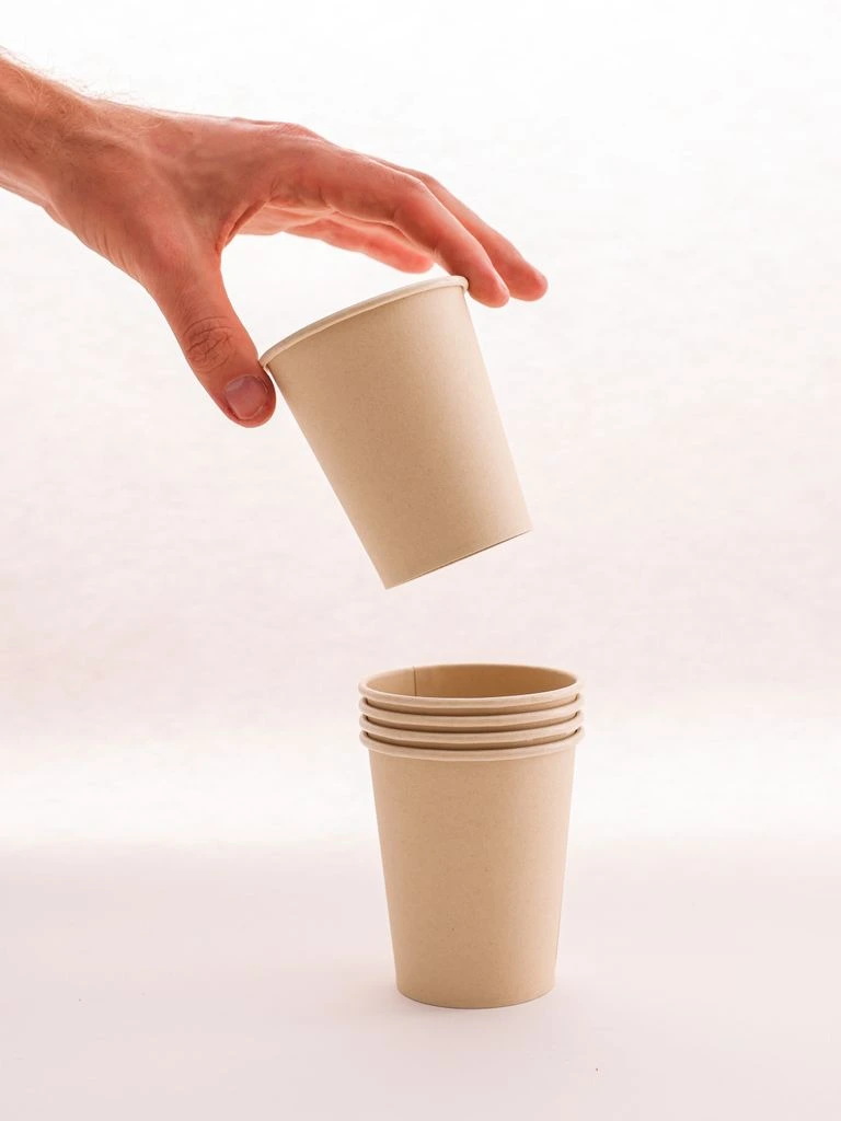 A compostable toothpaste tube presented as a printed specimen on cream paper
